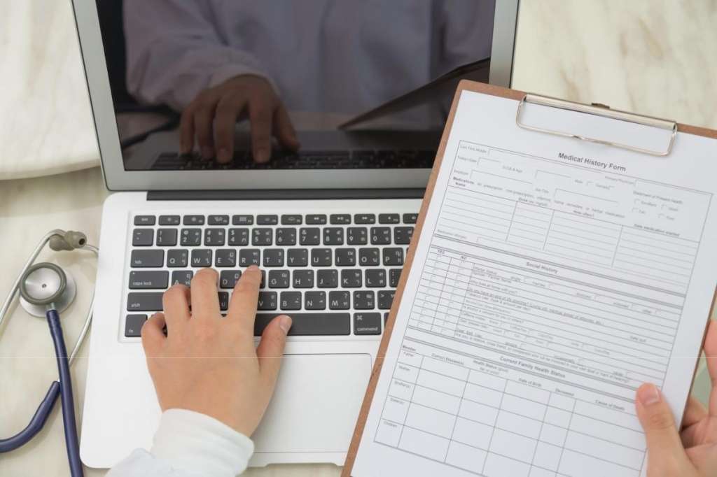 man doing date entry of claims