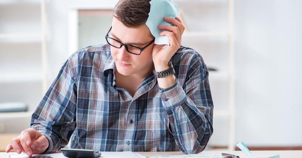 : "Discovering a Billing Error: Frustration and Confusion" "Person looking puzzled at a bill with calculator and pen in hand, indicating frustration over a billing error."