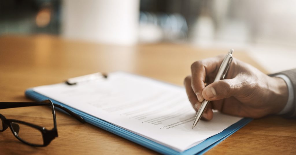  "Close-up of legal documents with highlighted sections and redacted text."