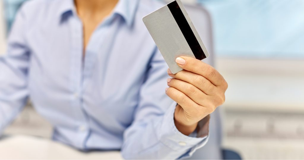  "Person handing over money at a doctor's office reception desk for a co-pay."