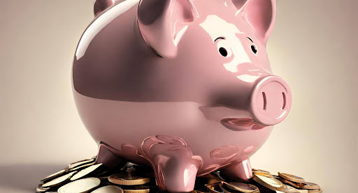 ("Savings Concept - Piggy Bank with Coins") ("Piggy bank filled with coins, symbolizing saving money.")